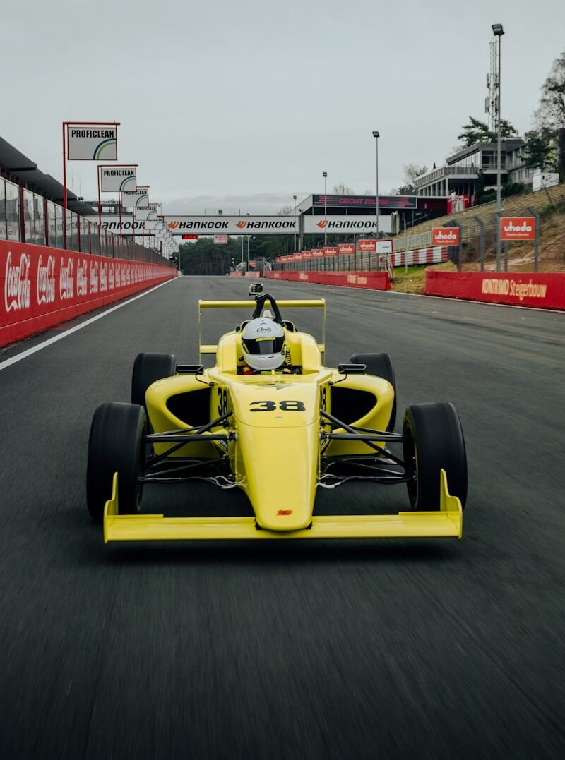 yellow and black f 1 car on road during daytime